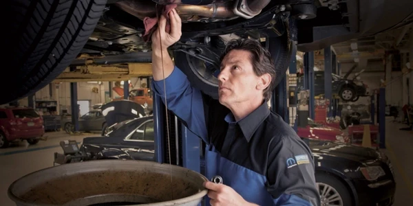 Certified technician servicing vehicle